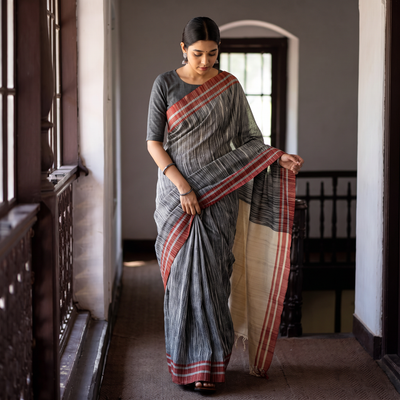 Grey & Kora Space Dyed Handspun Cotton Saree with Red Border, draped and worn by a woman, AI visual of the saree, iTokri