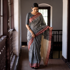 Grey & Kora Space Dyed Handspun Cotton Saree with Red Border, draped and worn by a woman, AI visual of the saree, iTokri