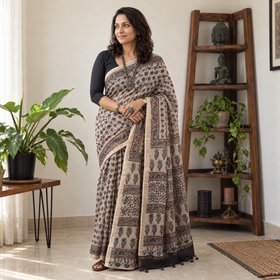 Beige Ajrakh hand block print natural dyed Kota Doria cotton saree, draped and worn by a woman, AI visual of the saree, iTokri