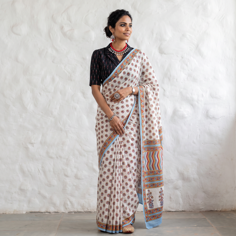 White hand block printed pure mul cotton Sanganeri saree, draped and worn by a woman, by artisan Santosh Dhanopia, AI visual of the saree, iTokri