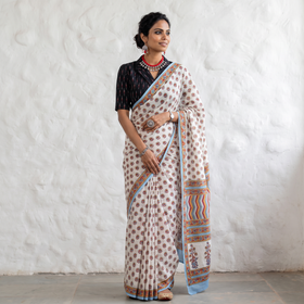 White hand block printed pure mul cotton Sanganeri saree, draped and worn by a woman, by artisan Santosh Dhanopia, AI visual of the saree, iTokri