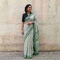 Green hand block printed pure mul cotton Sanganeri saree, draped and worn by a woman, by artisan Santosh Dhanopia, AI visual of the saree, iTokri
