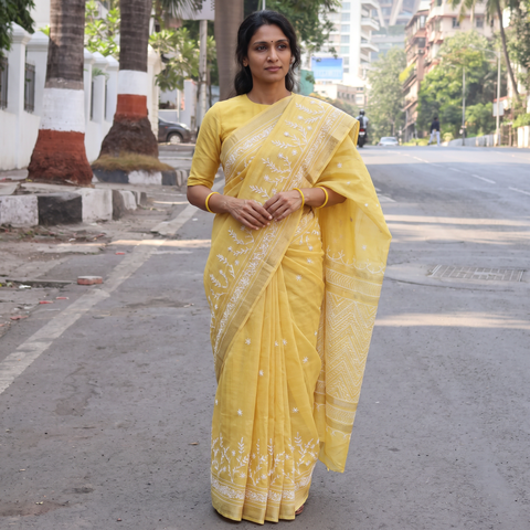 Yellow Hand Embroidered Chanderi Silk Zari Border Chikankari Lucknowi Saree, draped and worn by a woman, AI visual of the saree, iTokri