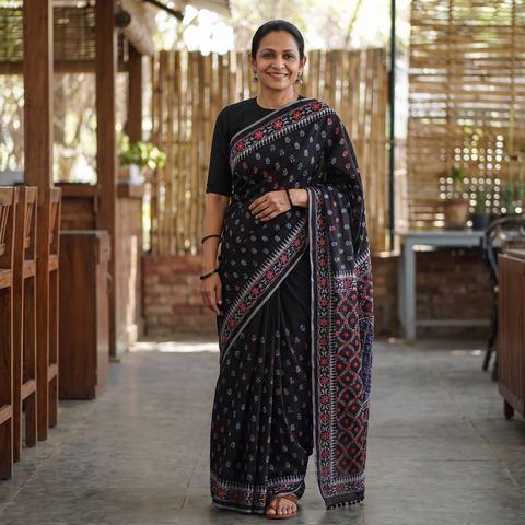 Black Hand Embroidered Chapa Work Silk Cotton Saree, draped and worn by a woman, AI visual of the saree, iTokri