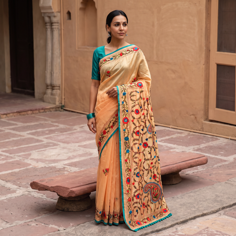 Peach Hand Embroidered Chapa Work Silk Cotton Saree, draped and worn by a woman, AI visual of the saree, iTokri