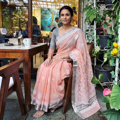 Peach Hand Embroidered Kota Doria Cotton Lucknowi Chikankari Saree with Border, draped and worn by a woman, AI visual of the saree, iTokri