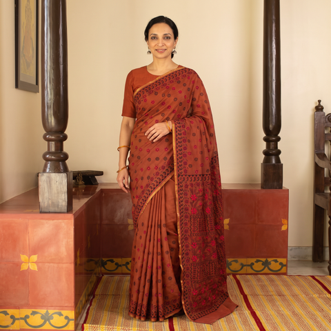 Red Hand Embroidered Silk Cotton Chapa Work Saree, draped and worn by a woman, AI visual of the saree, iTokri