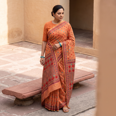 Orange Hand Embroidered Silk Cotton Chapa Work Saree, draped and worn by a woman, AI visual of the saree, iTokri