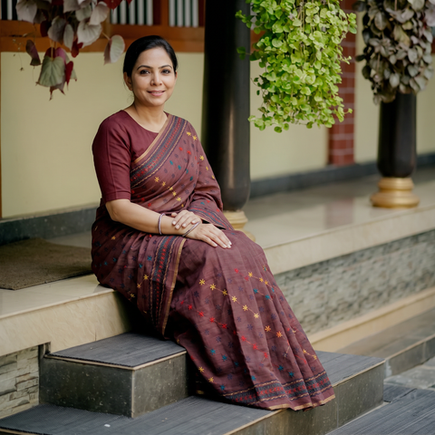 Maroon Hand Embroidered Silk Cotton Chapa Work Saree, draped and worn by a woman, AI visual of the saree, iTokri