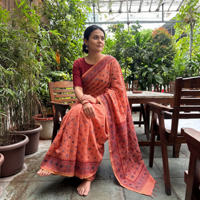 Peach Hand Embroidered Silk Cotton Chapa Work Saree, draped and worn by a woman, AI visual of the saree, iTokri