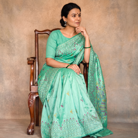 Green Hand Embroidered Silk Saree, draped and worn by a woman, AI visual of the saree, iTokri