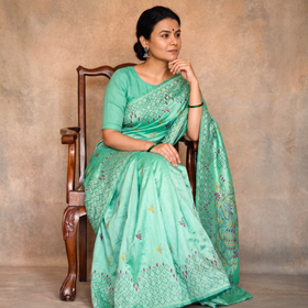 Green Hand Embroidered Silk Saree, draped and worn by a woman, AI visual of the saree, iTokri