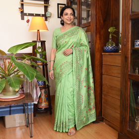 Green Hand Embroidered Silk Saree, draped and worn by a woman, AI visual of the saree, iTokri