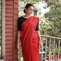 Red Hand Embroidered Silk Saree, draped and worn by a woman, AI visual of the saree, iTokri
