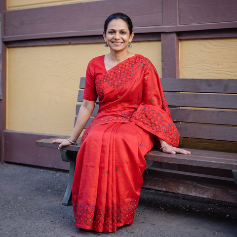 Red Hand Embroidered Silk Saree, draped and worn by a woman, AI visual of the saree, iTokri