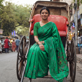 Green Hand Embroidered Silk Saree, draped and worn by a woman, AI visual of the saree, iTokri