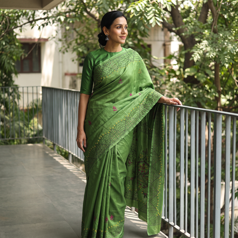 Green Hand Embroidered Silk Saree, draped and worn by a woman, AI visual of the saree, iTokri