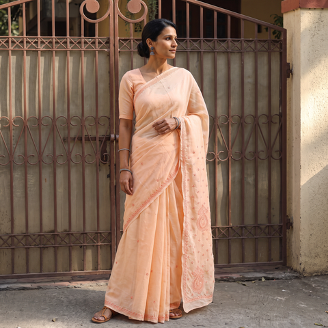Peach Hand Embroidered Terivoile Cotton Lucknowi Chikankari Saree, draped and worn by a woman, AI visual of the saree, iTokri