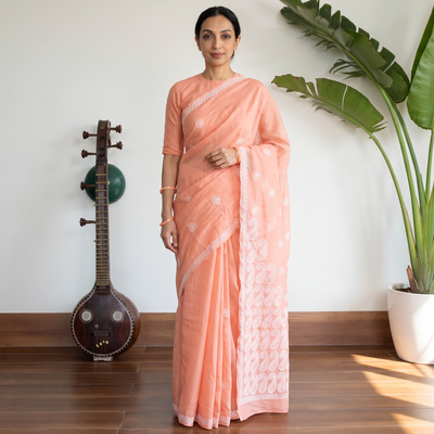 Peach Hand Embroidered Terivoile Cotton Lucknowi Chikankari Saree, draped and worn by a woman, AI visual of the saree, iTokri
