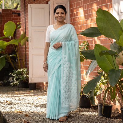 Blue Hand Embroidered Terivoile Cotton Lucknowi Chikankari Saree, draped and worn by a woman, AI visual of the saree, iTokri