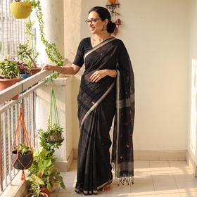 Black Handloom Cotton Phulia Jamdani Saree with Tassels, draped and worn by a woman, AI visual of the saree, iTokri