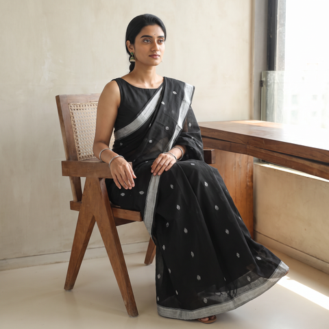 Black Handloom Cotton Phulia Jamdani Saree with Tassels, draped and worn by a woman, AI visual of the saree, iTokri