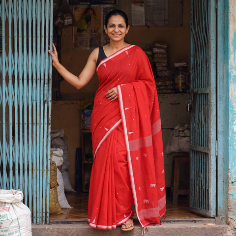 Red Handloom Cotton Phulia Jamdani Saree with Tassels, draped and worn by a woman, AI visual of the saree, iTokri