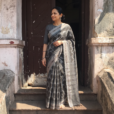 Black Handloom Cotton Sambalpuri Ikat Saree, draped and worn by a woman, AI visual of the saree, iTokri
