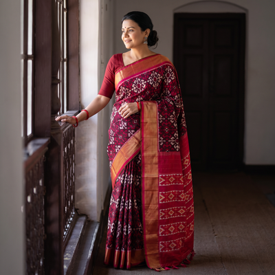 Maroon Handloom Mulberry Silk Patola Ikat Pochampally Saree, draped and worn by a woman, AI visual of the saree, iTokri