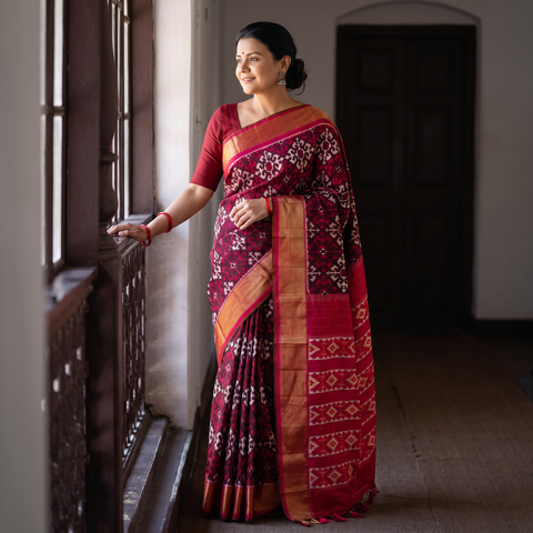 Maroon Handloom Mulberry Silk Patola Ikat Pochampally Saree, draped and worn by a woman, AI visual of the saree, iTokri