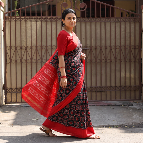 Black Handloom Mulberry Silk Patola Ikat Pochampally Saree, draped and worn by a woman, AI visual of the saree, iTokri