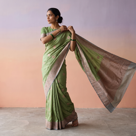 Green Handloom Pure Katan Silk Kaduwa Zari Buti Banarasi Saree, draped and worn by a woman, AI visual of the saree, iTokri