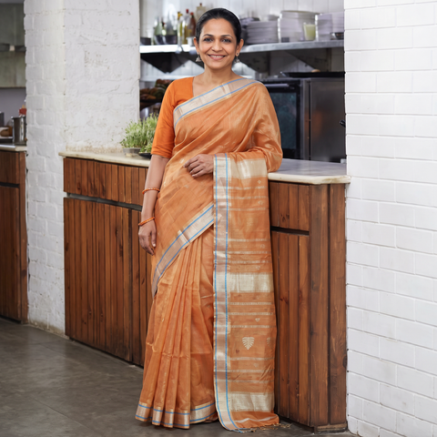 Peach Handloom Tissue Zari Weave Silk Cotton Buti Maheshwari Saree with Zari Border, draped and worn by a woman, AI visual of the saree, iTokri