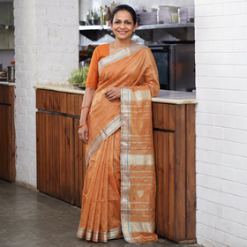 Peach Handloom Tissue Zari Weave Silk Cotton Buti Maheshwari Saree with Zari Border, draped and worn by a woman, AI visual of the saree, iTokri