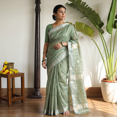 Green Handloom Tissue Zari Weave Silk Cotton Buti Maheshwari Saree with Zari Border, draped and worn by a woman, AI visual of the saree, iTokri
