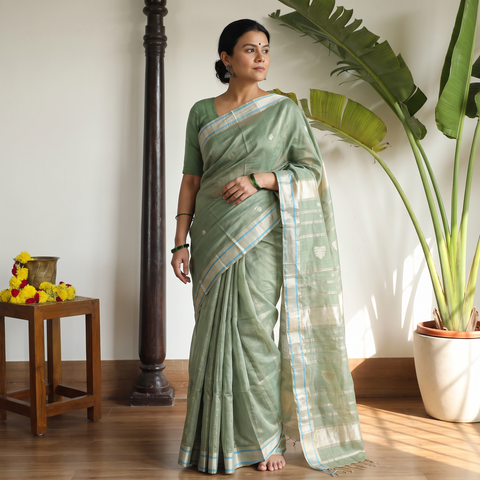 Green Handloom Tissue Zari Weave Silk Cotton Buti Maheshwari Saree with Zari Border, draped and worn by a woman, AI visual of the saree, iTokri