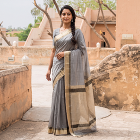Grey Handloom Zari Border Maheshwari Silk Saree, draped and worn by a woman, AI visual of the saree, iTokri
