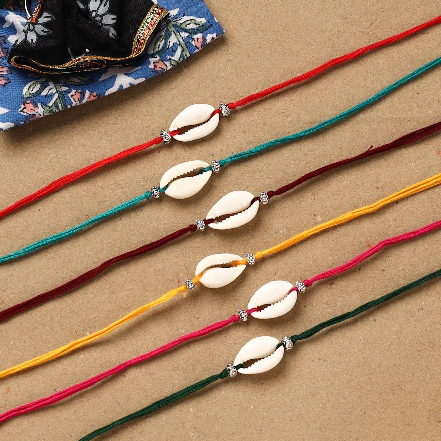 Handmade jute fabart shell work rakhi (set of 6) 160