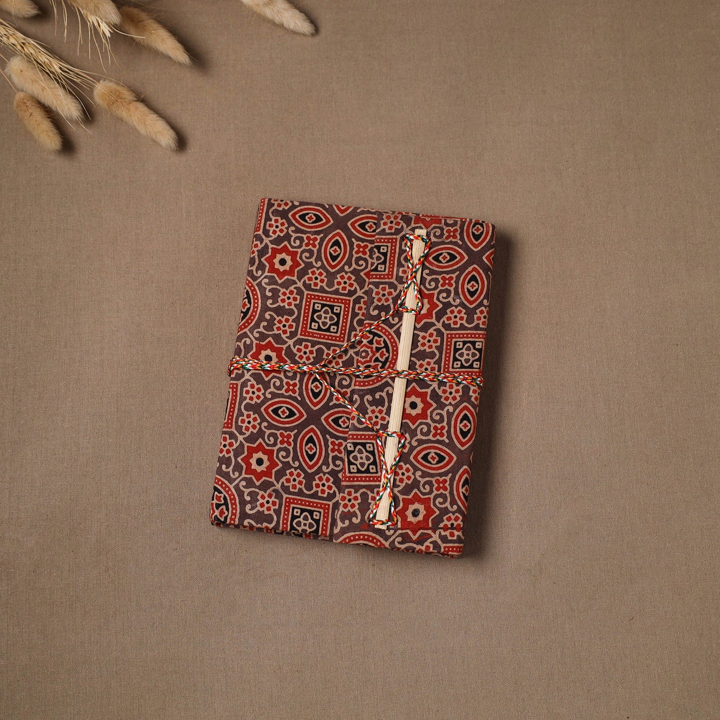 Handmade paper notebook in ajrakh fabric cover with thread