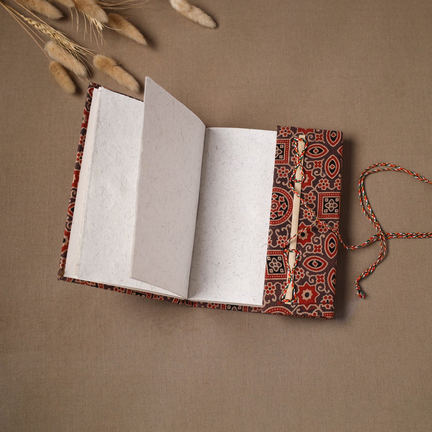 Handmade paper notebook in ajrakh fabric cover with thread