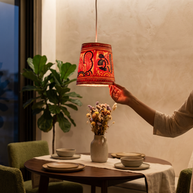 Handpainted Tholu Bommalata Leather Hanging Lamp, lit in a home in the evening, AI visual of the light, iTokri