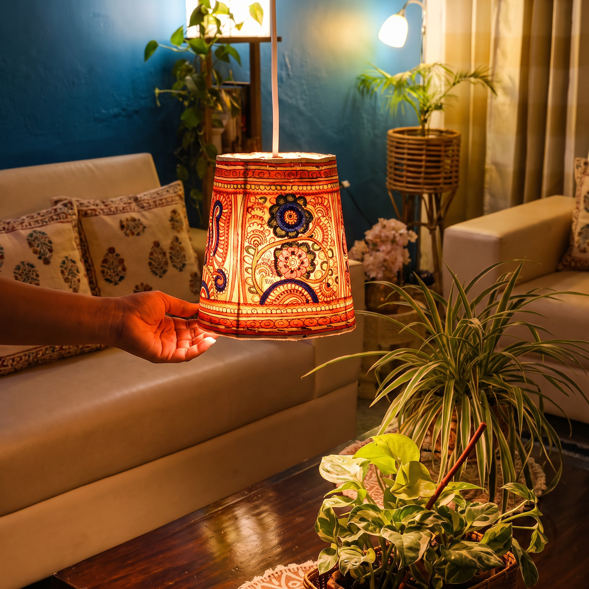 Handpainted Tholu Bommalata Leather Hanging Lamp, lit in a home in the evening, AI visual of the light, iTokri