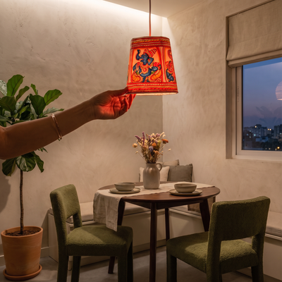 Handpainted Tholu Bommalata Leather Hanging Lamp, lit in a home in the evening, AI visual of the light, iTokri