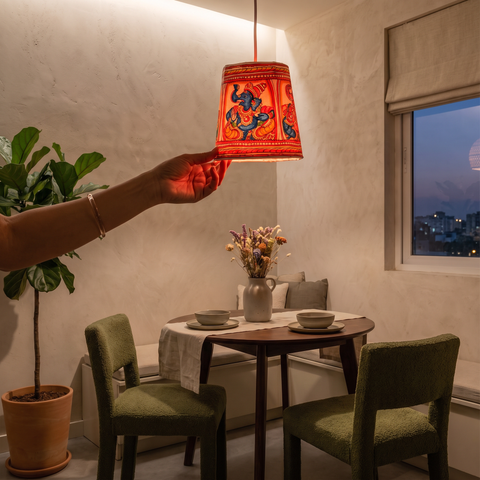 Handpainted Tholu Bommalata Leather Hanging Lamp, lit in a home in the evening, AI visual of the light, iTokri