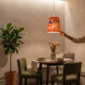 Handpainted Tholu Bommalata Leather Hanging Lamp, lit in a home in the evening, AI visual of the light, iTokri