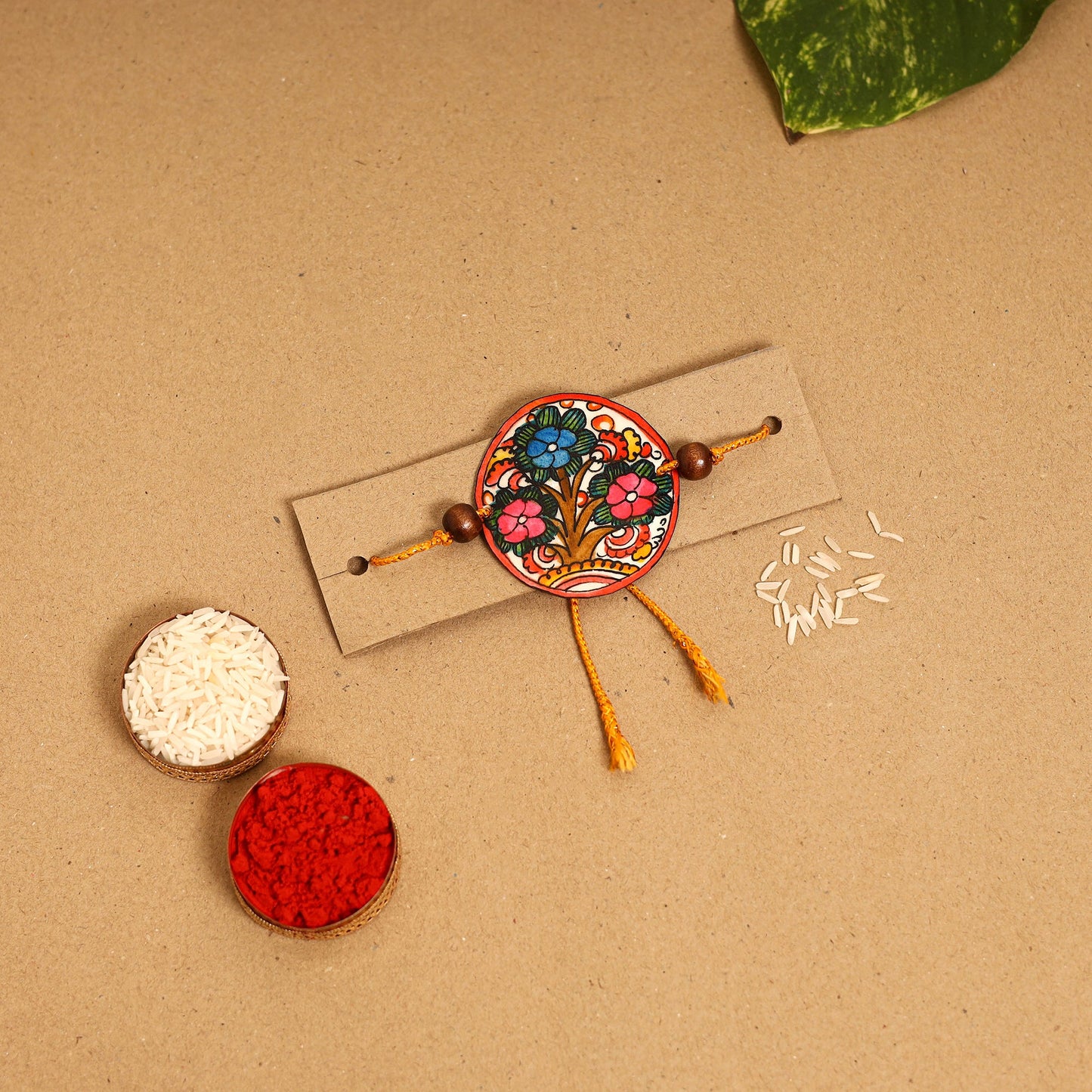  Handpainted Tholu Bommalata Leather Rakhi 