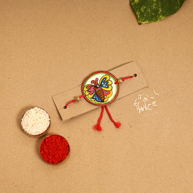  Handpainted Tholu Bommalata Leather Rakhi 