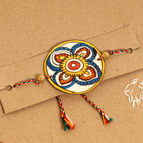  Handpainted Tholu Bommalata Leather Rakhi 