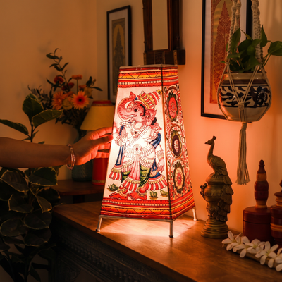Handpainted Tholu Bommalata Leather Table Lamp (Big), lit in a home in the evening, AI visual of the light, iTokri