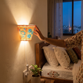 Handpainted Tholu Bommalata Leather Wall Lamp (Small), lit in a home in the evening, AI visual of the light, iTokri